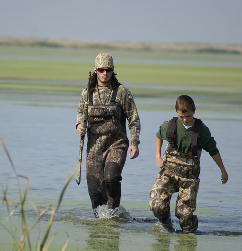 youth duck hunt, walking through the marsh